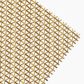 Gold-finish woven wire mesh panel with interlocking flat and round metal wires, shown corner-on against a white background